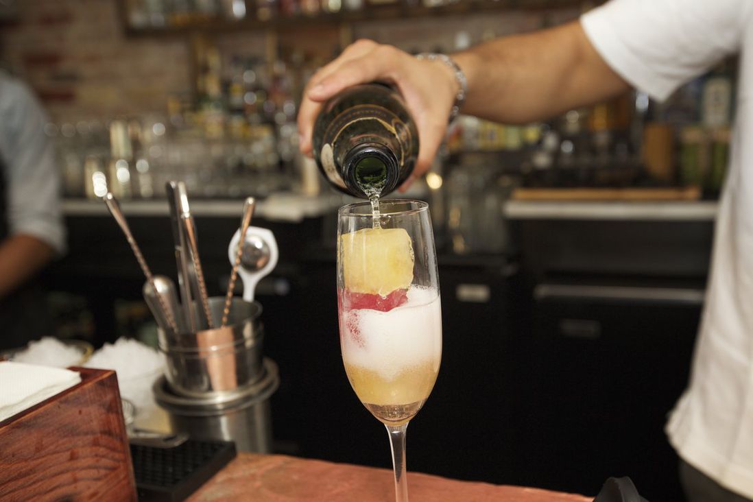 The bottomless Mimosa, champagne filled with cubes of frozen orange and cranberry juice, at The Kitchen Step<br>